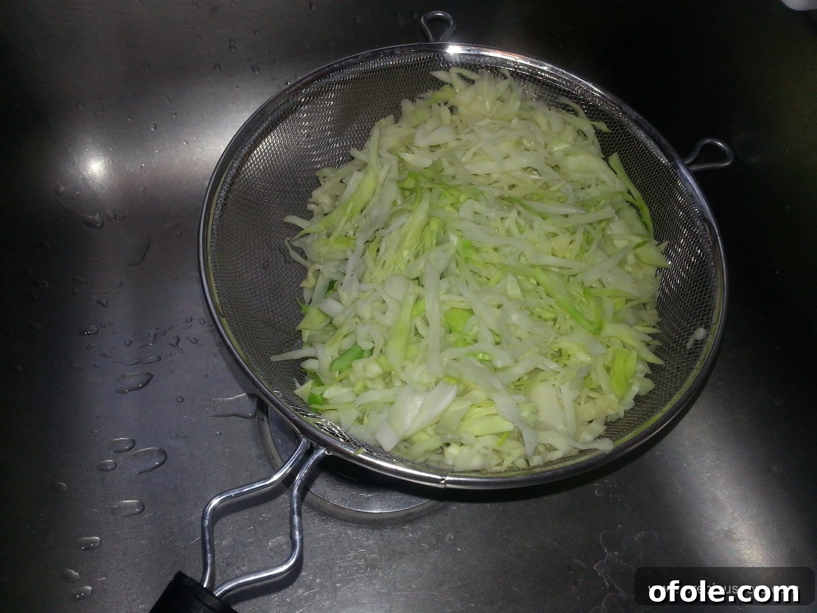 Freshly blanched and thoroughly drained cabbage, expertly chopped into uniform strips, ready for integration into the mixed vegetable recipe.