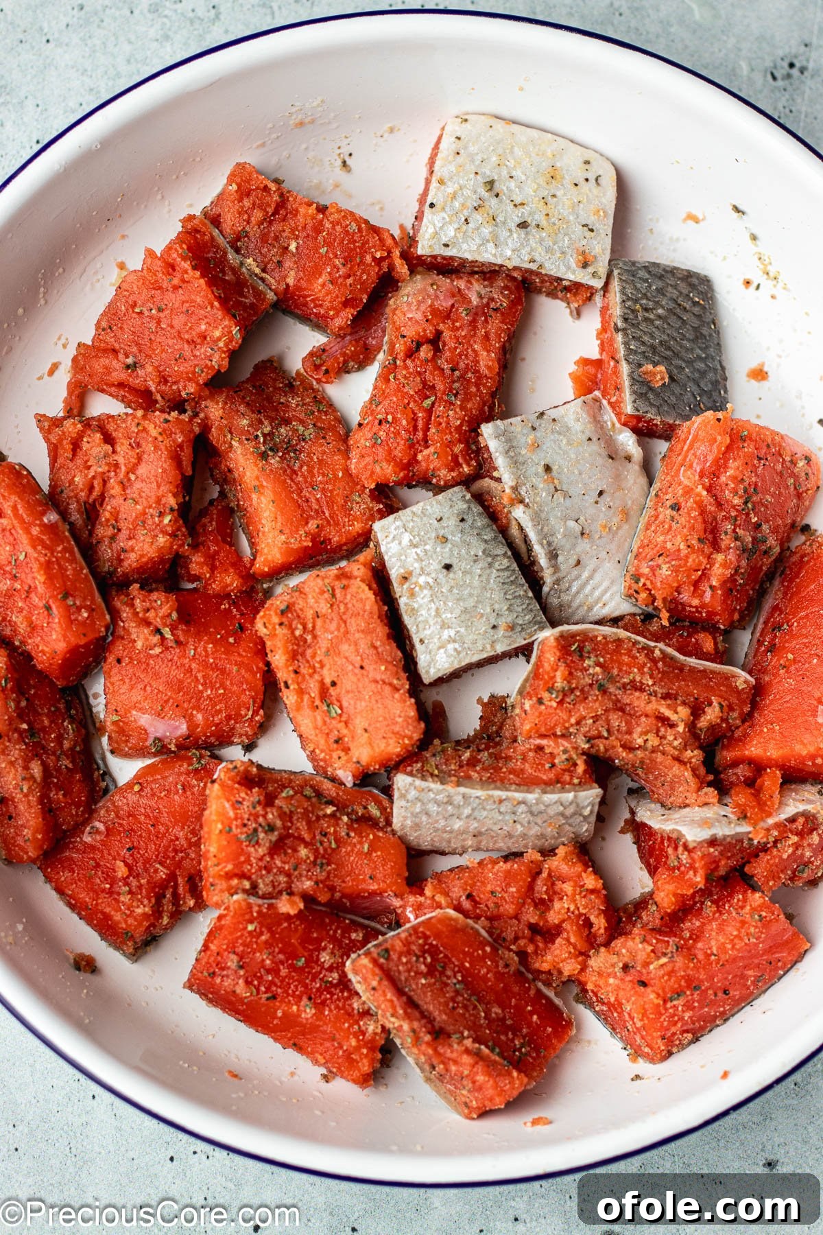 Irresistible Salmon Bites 6 Seasoned salmon cubes in a mixing bowl, ready to cook.