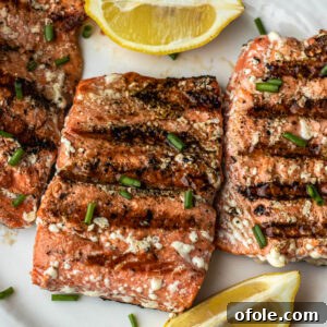 Grilled Sockeye Salmon steaks on a white plate, ready to eat.