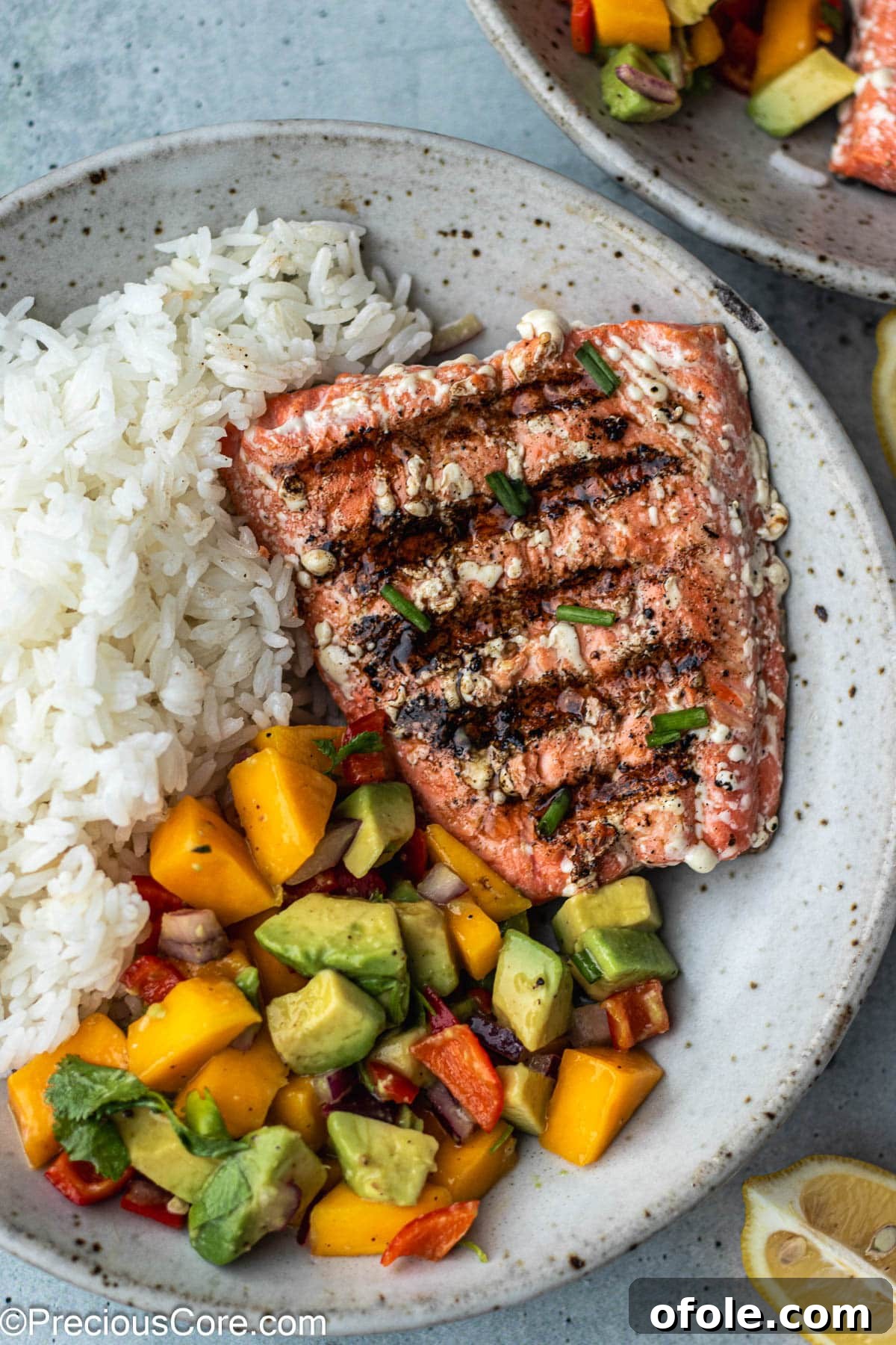 A bowl of garlic herb rice served with grilled sockeye salmon on top.