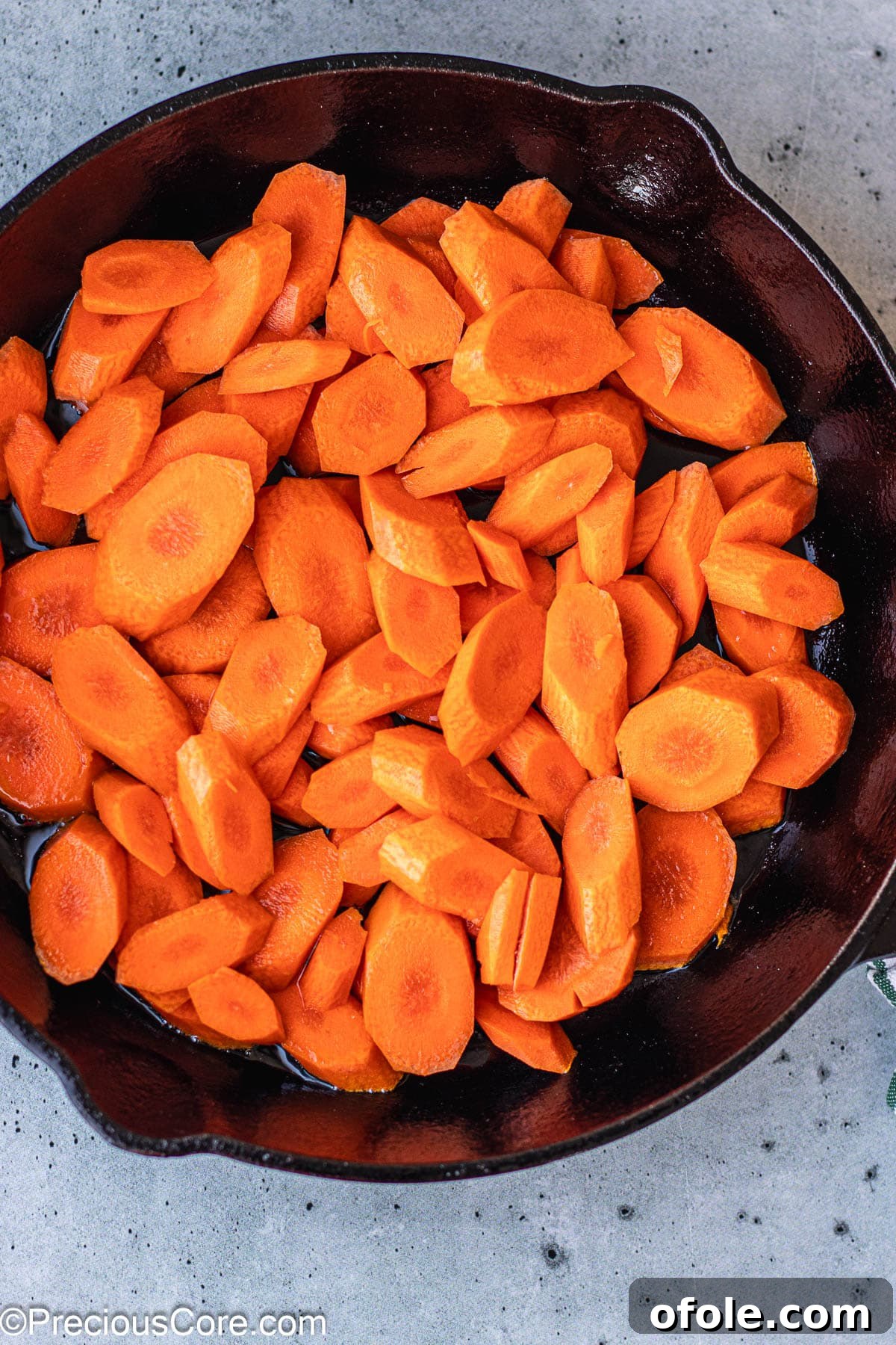Caramelized Carrots 5 Carrot slices in a cast iron skillet.