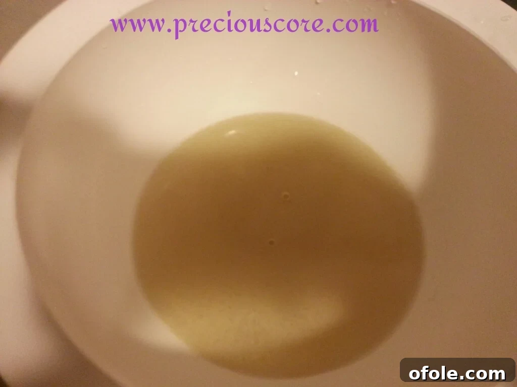 Activating Yeast: First Step to Fluffy Bread Yeast dissolving in warm water for Kumba Bread recipe
