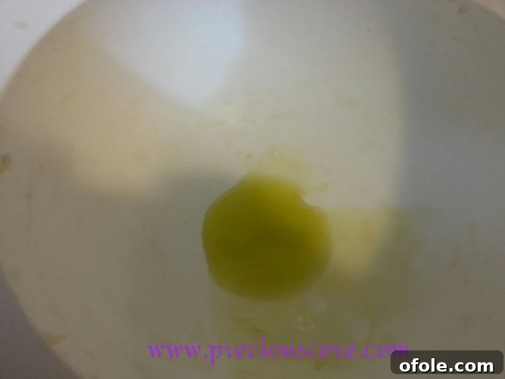 Greasing the Bowl for First Rise Spreading vegetable oil around the inside of a mixing bowl