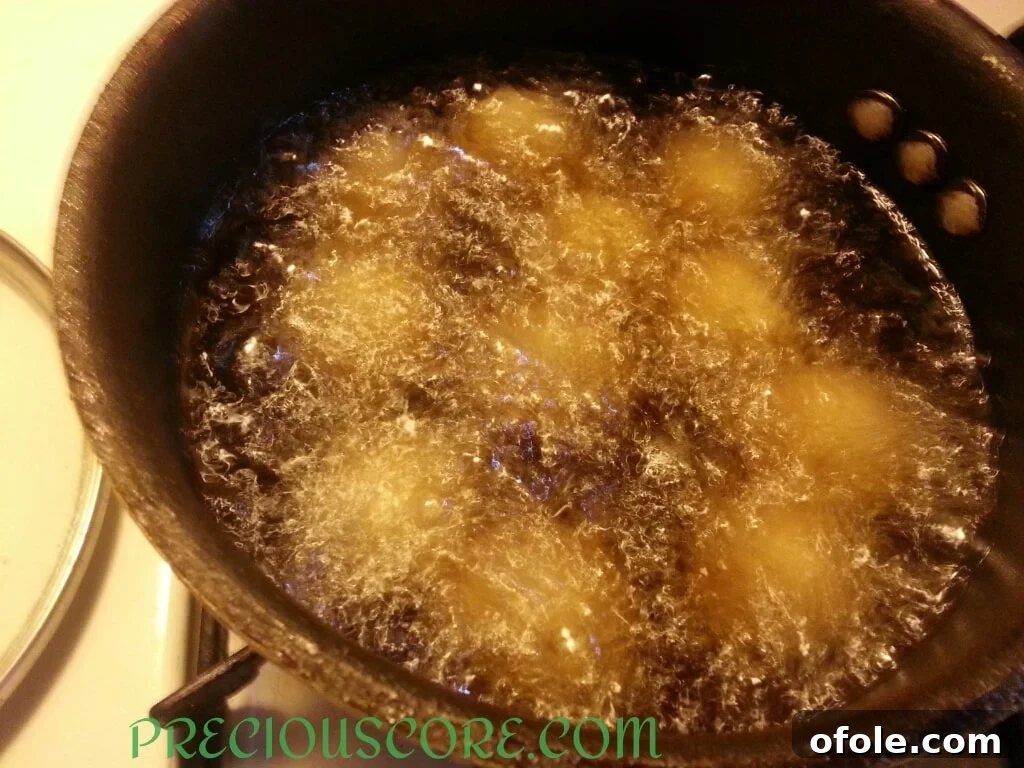 Golden-brown Accra Banana fritters frying