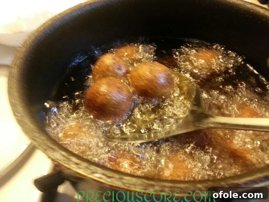 Freshly fried Accra Banana fritters draining on paper towel