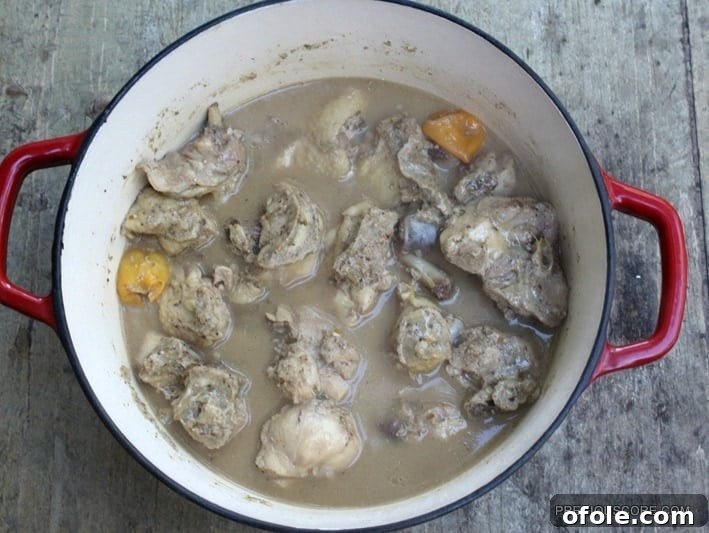Chicken Pepper Soup simmering on the stove, steam rising