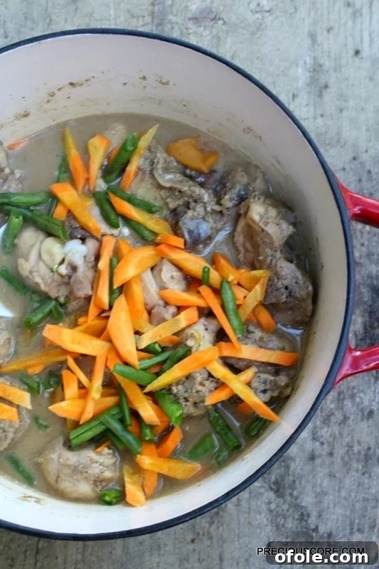 Chicken Pepper Soup with carrots and green beans, showing the finished dish in a pot