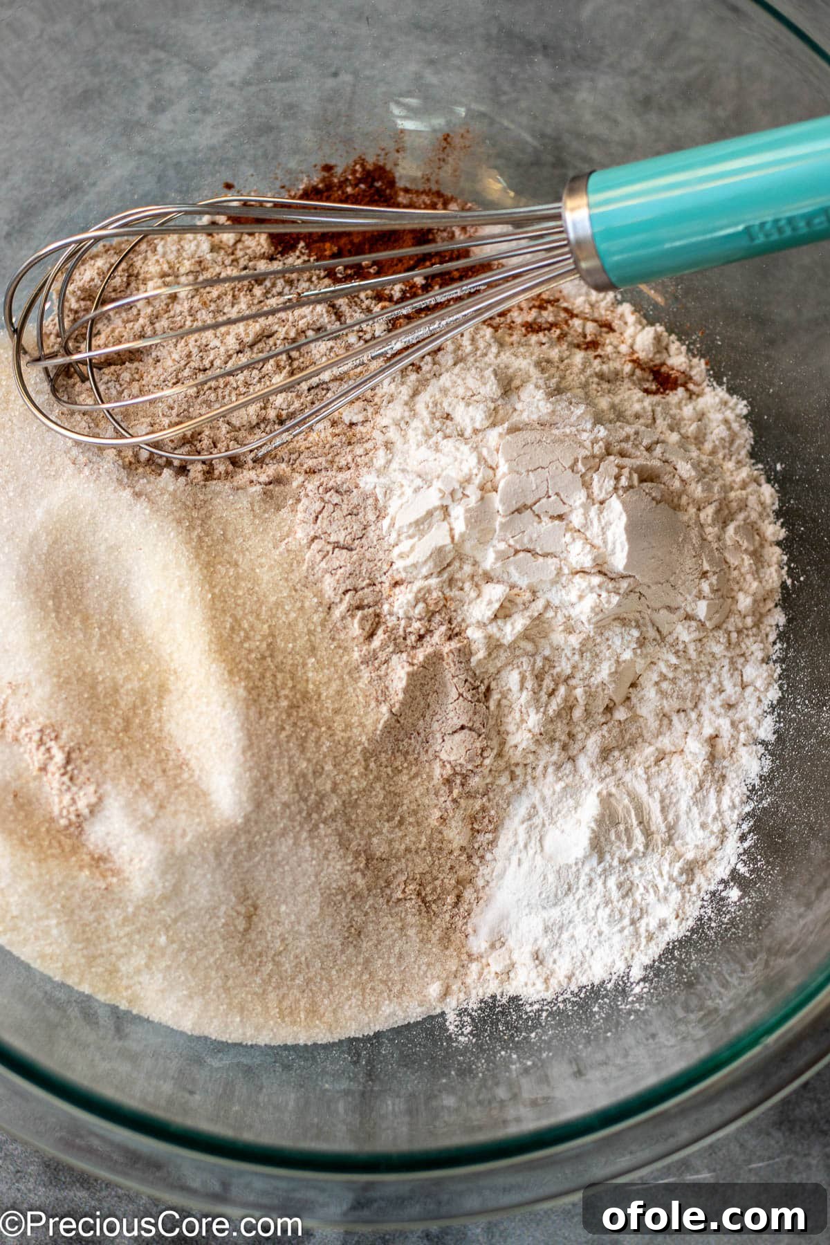 Dry ingredients for muffins in a mixing bowl before whisking.