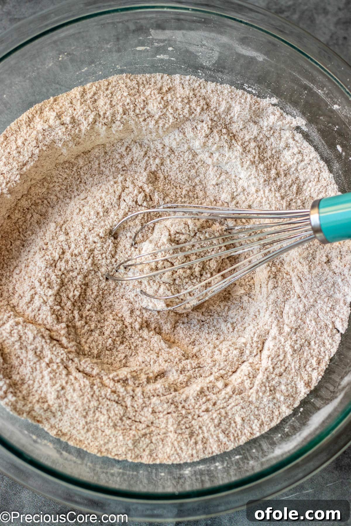 Dry ingredients for muffins whisked together smoothly in a bowl.