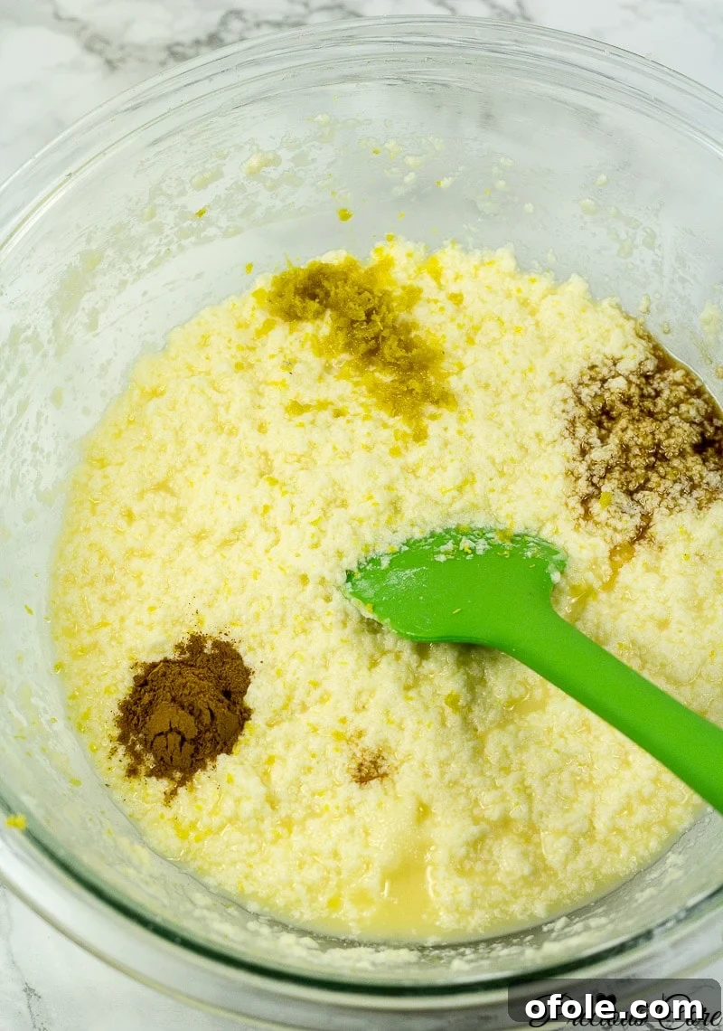 Timeless Fresh Apple Cake 9 Wet ingredients including milk, vanilla, lemon zest, and cinnamon powder added to the batter.