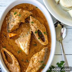 Njangsa sauce in a white oval bowl with white yams on the side.