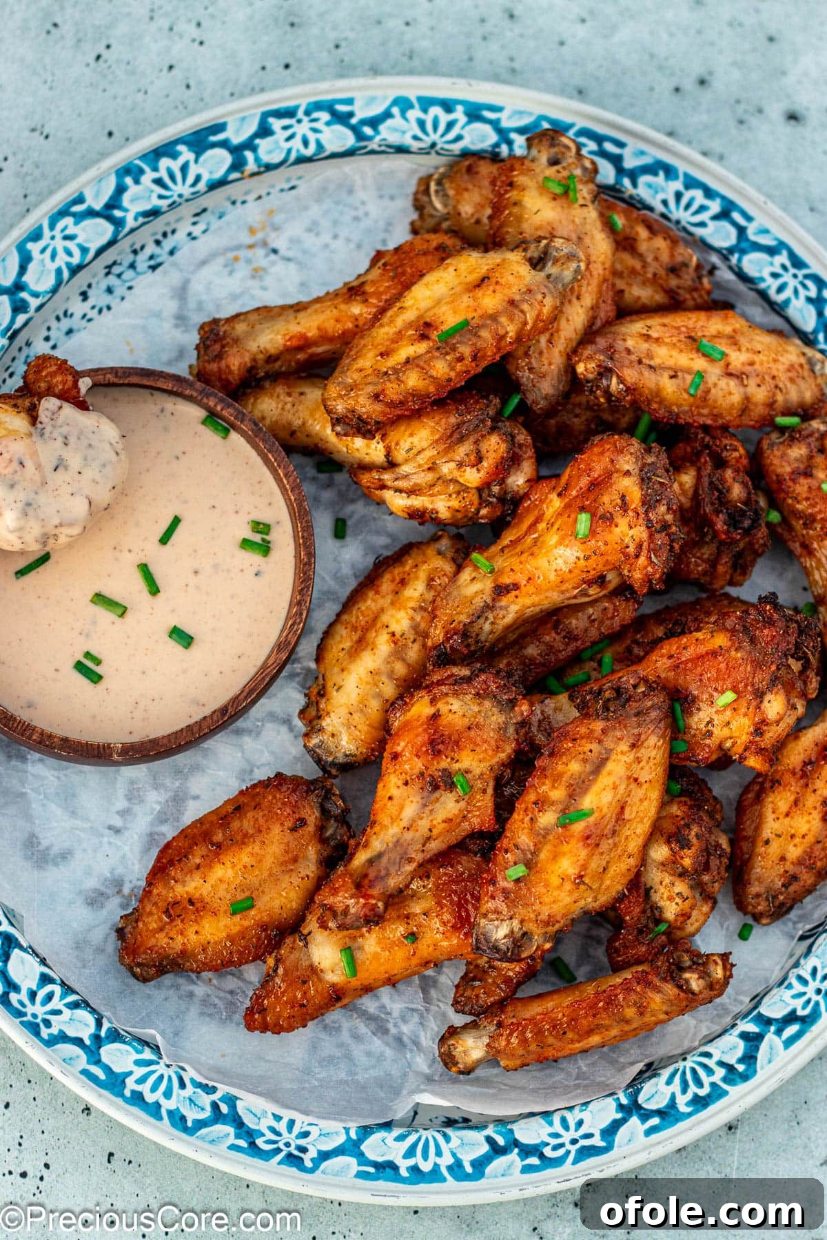Crispy Golden Spiced Wings 8 A perfectly baked dry rub chicken wing generously coated in ranch dressing, ready to be enjoyed.