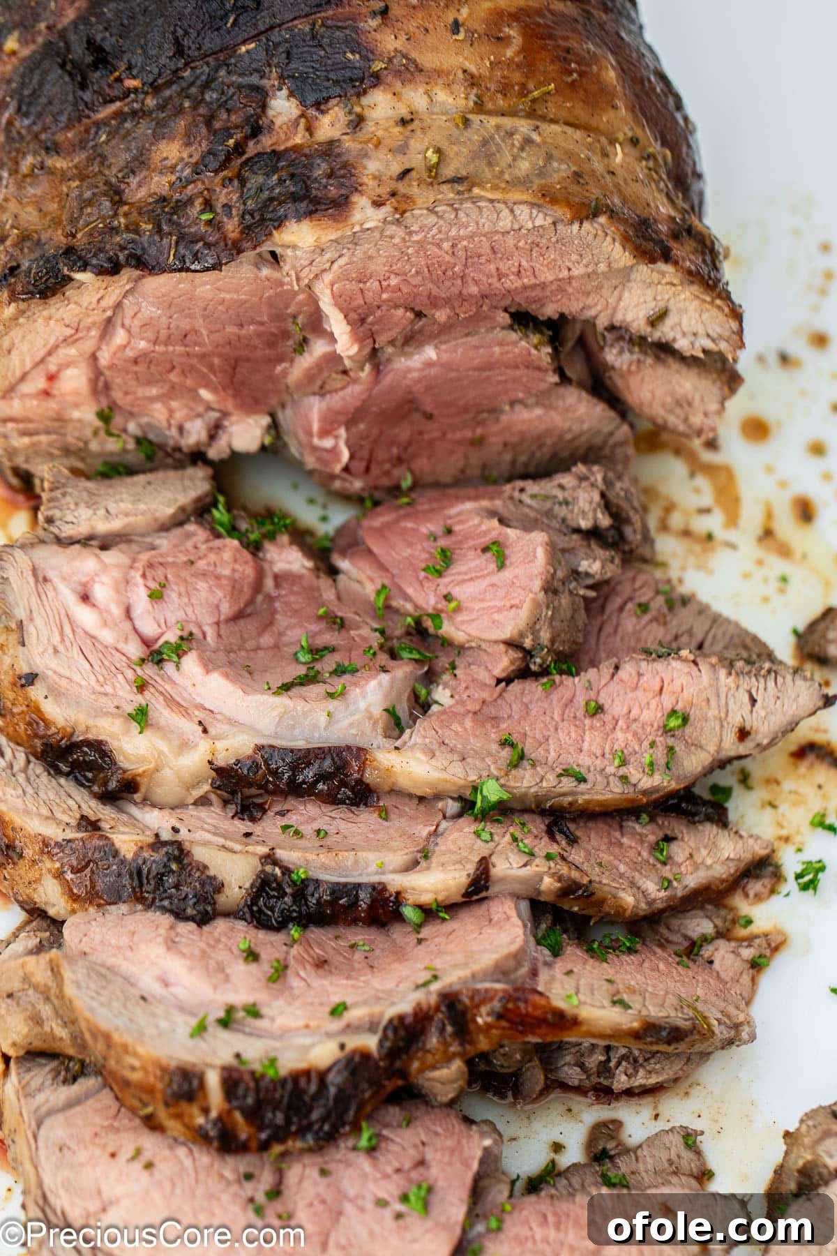 A beautifully sliced roasted boneless leg of lamb, ready to serve.