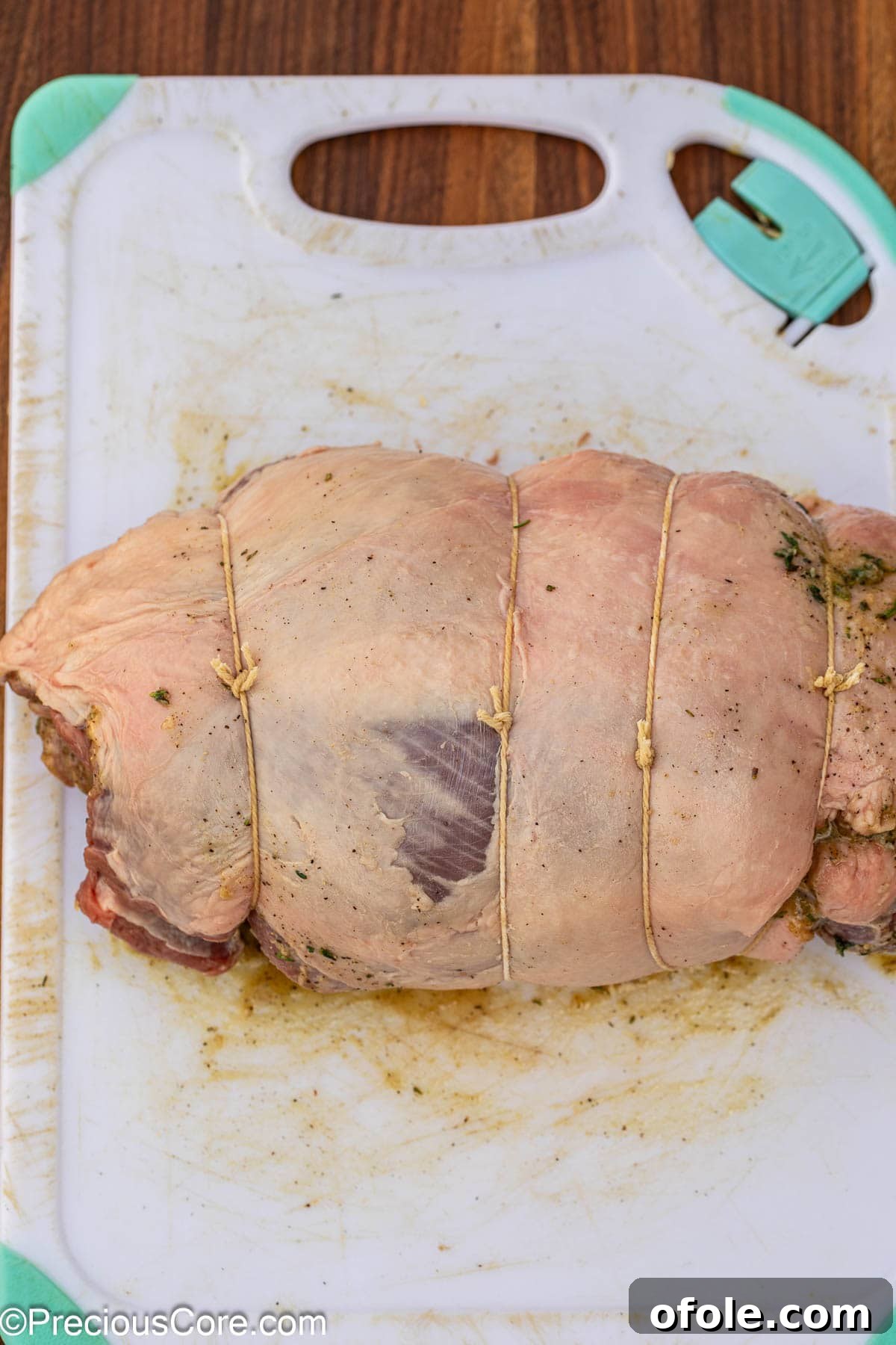 A rolled boneless lamb leg securely tied with butcher's twine.