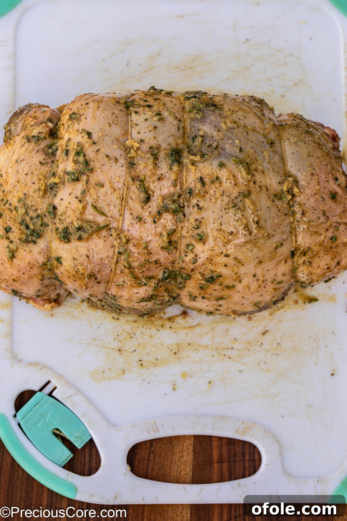 A fully seasoned and tied boneless leg of lamb, ready for marinating.