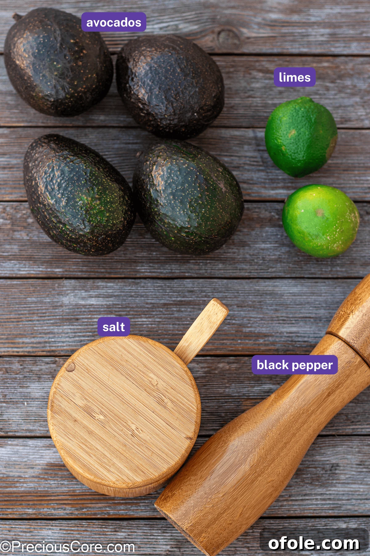 The four essential ingredients for guacamole laid out: ripe avocados, fresh limes, a pinch of salt, and a dash of black pepper, all ready for preparation.