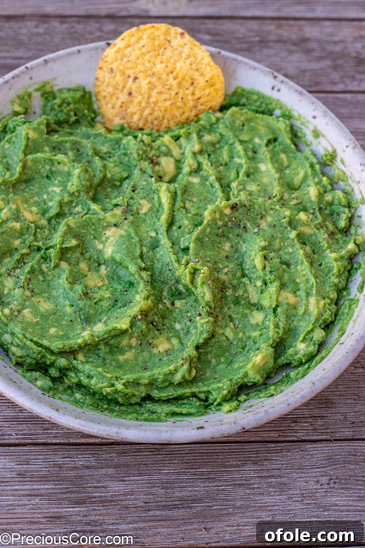 A beautifully textured bowl of 4-ingredient guacamole, smooth yet with slight chunks, highlighting its fresh appeal, perfect for immediate enjoyment.