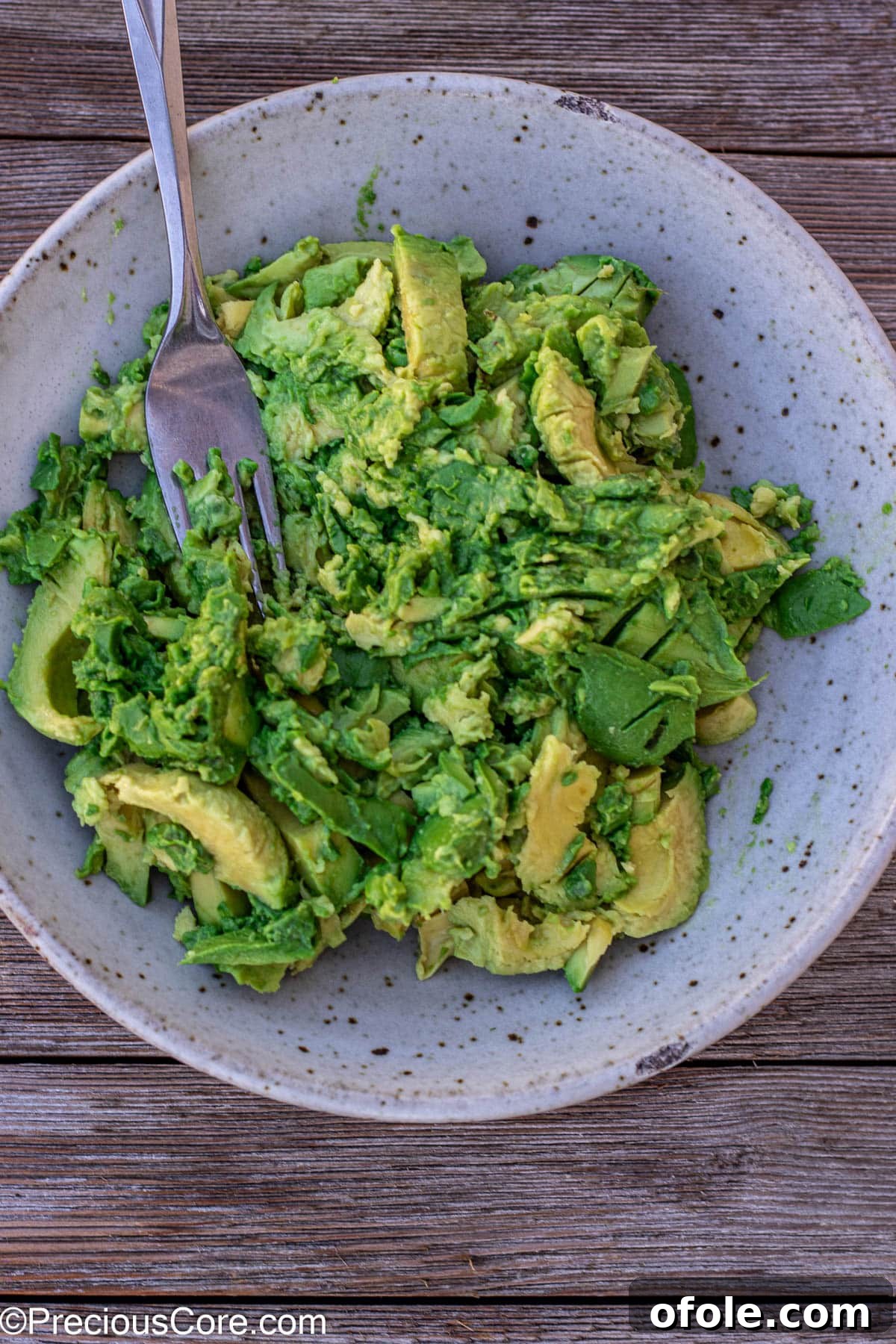 Effortless 4-Ingredient Guacamole 7 Mashing avocados with a fork.
