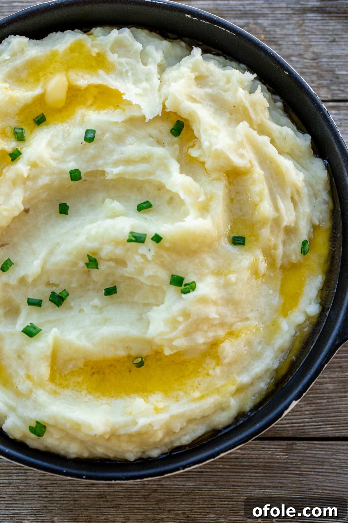 Roast Chicken's Best Supporting Dishes 2 Creamy Buttermilk Mashed Potatoes, generously topped with fresh chopped green onions, making an ideal side dish for a hearty roast chicken meal.
