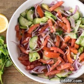A vibrant bowl of Kachumbari, a fresh and zesty Kenyan tomato and onion salad.