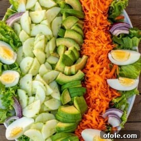 A refreshing platter showcasing crisp lettuce, vibrant cucumbers, and a medley of other fresh salad vegetables.
