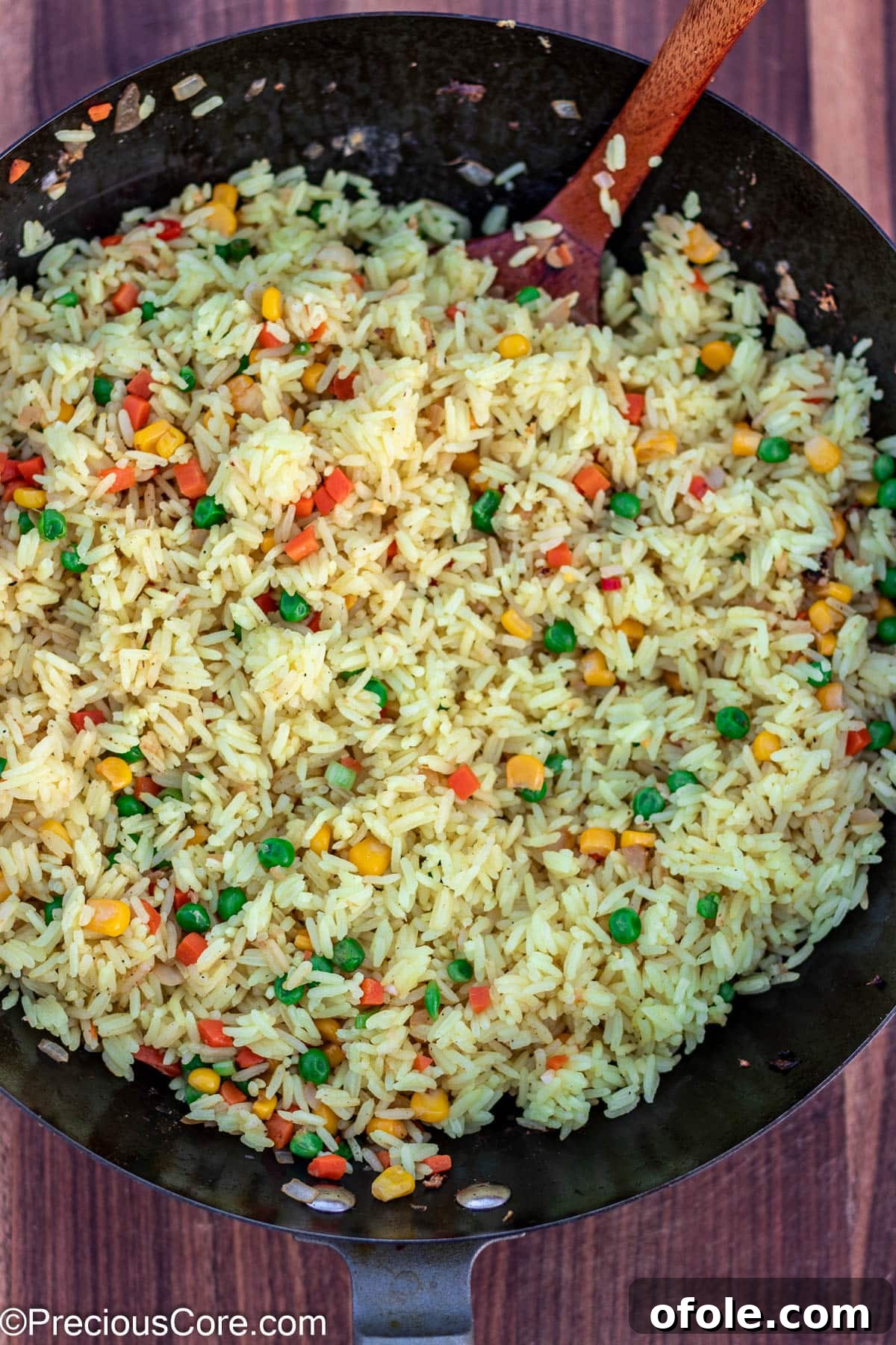 Signature Surf & Turf Fried Rice 11 Rice being stir-fried with vegetables in a wok.