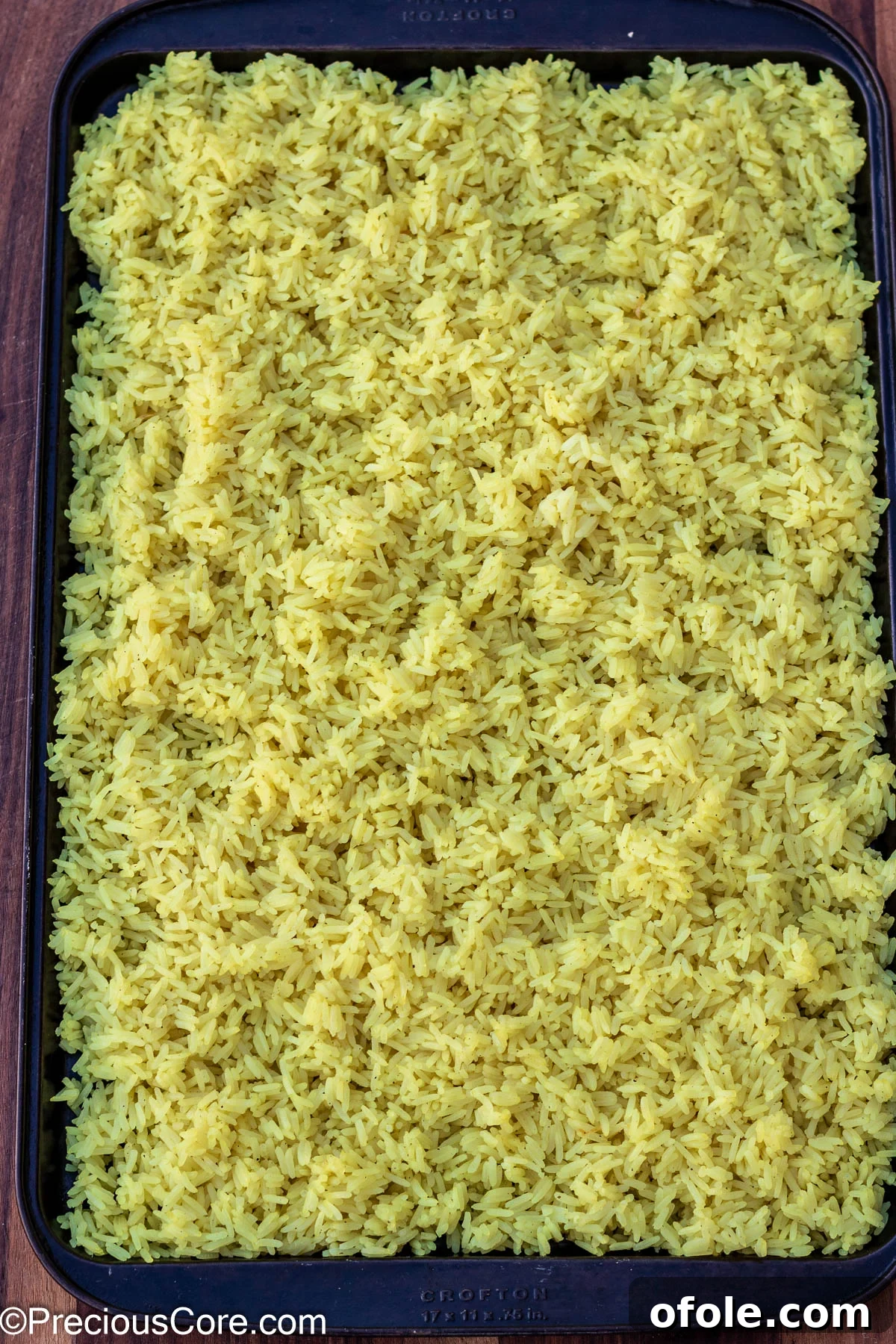 Signature Surf & Turf Fried Rice 4 Cooked jasmine rice spread on a tray, ready for frying.