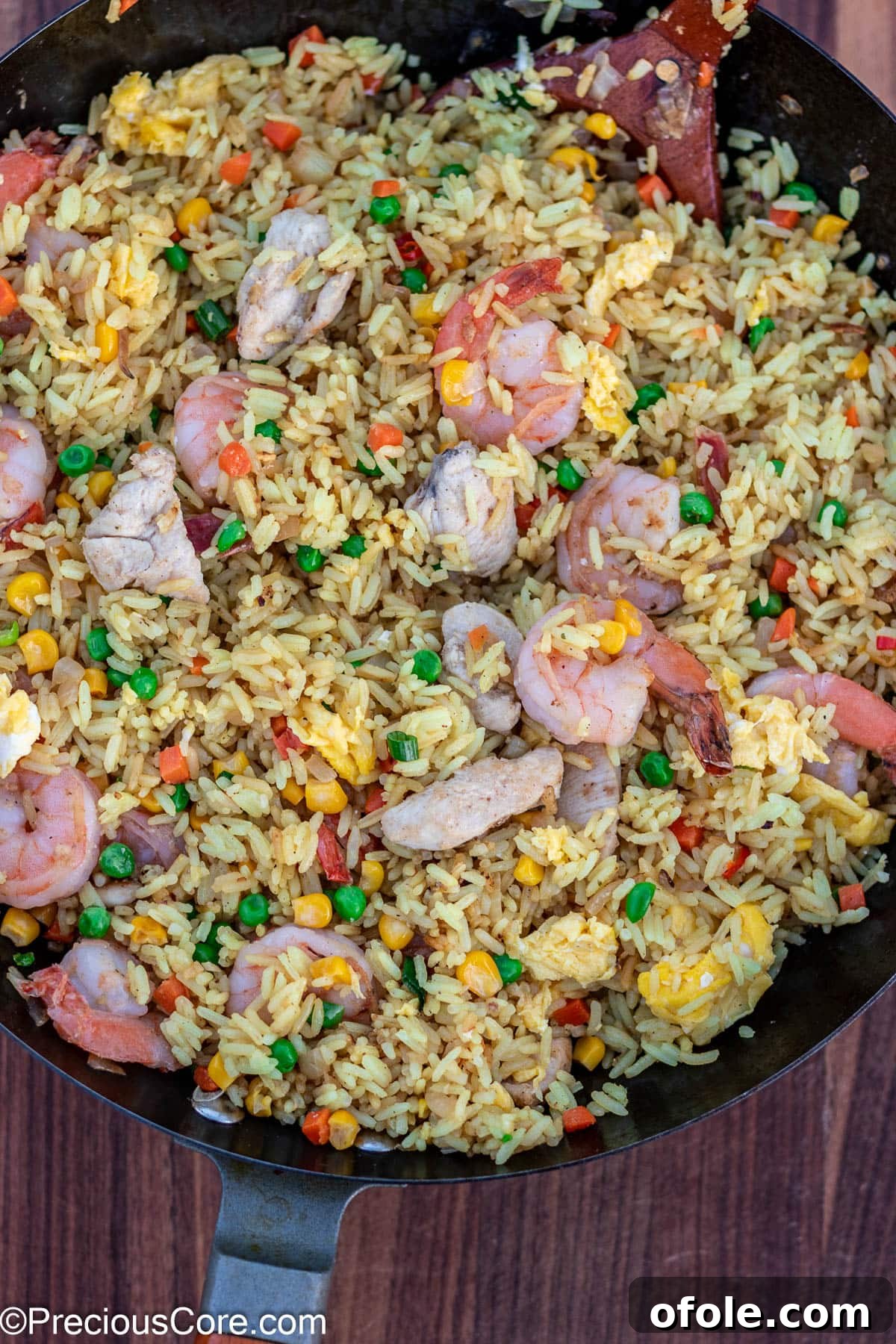 Signature Surf & Turf Fried Rice 6 Fried rice being stir-fried in a large wok.