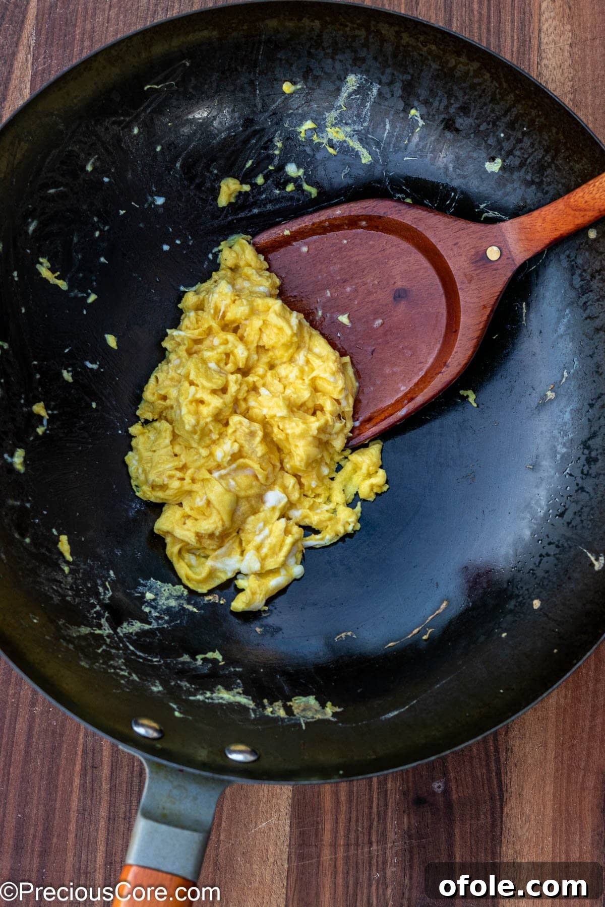 Signature Surf & Turf Fried Rice 7 Scrambled eggs cooking in a wok.