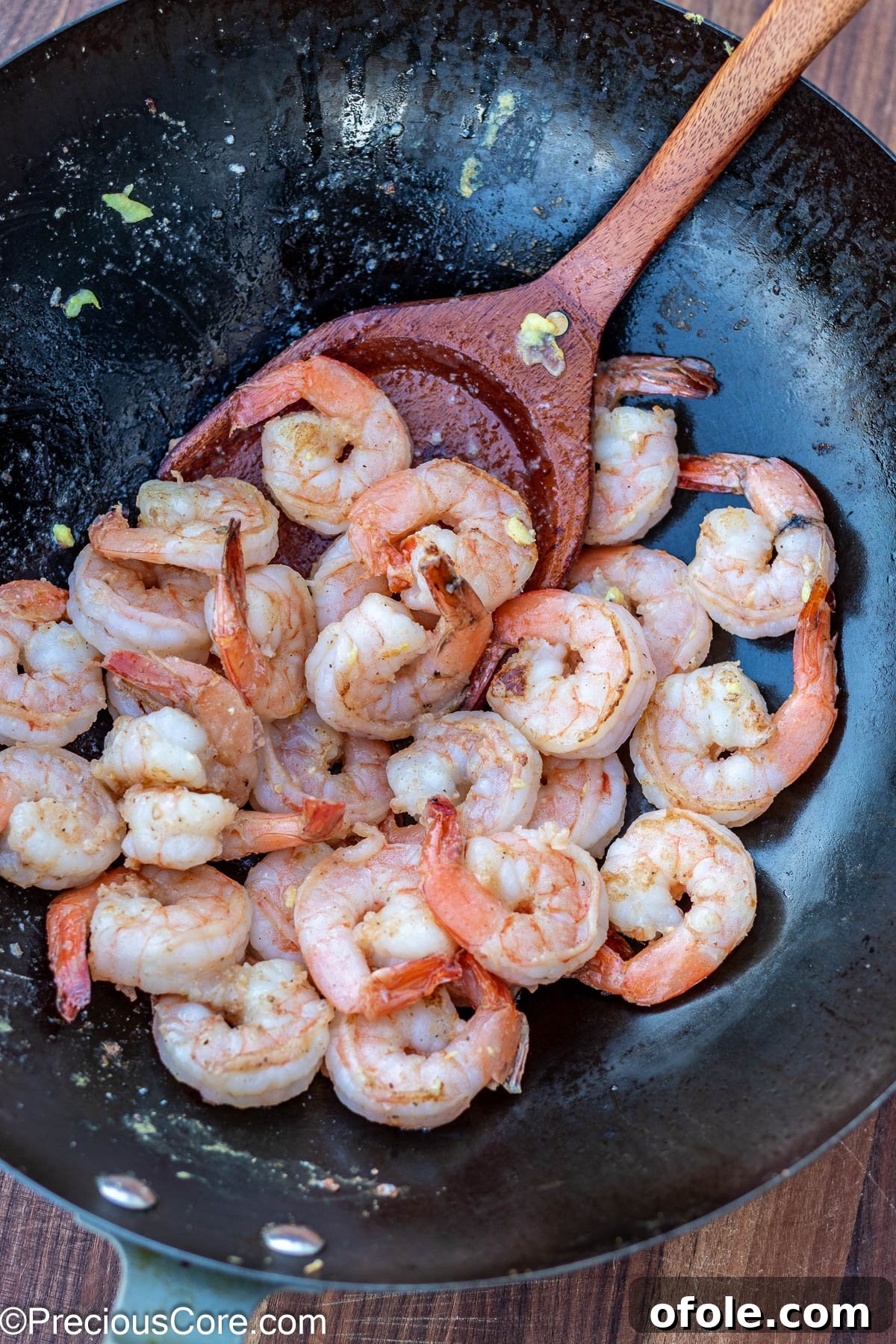 Signature Surf & Turf Fried Rice 8 Cooked shrimp in a wok, before being removed.