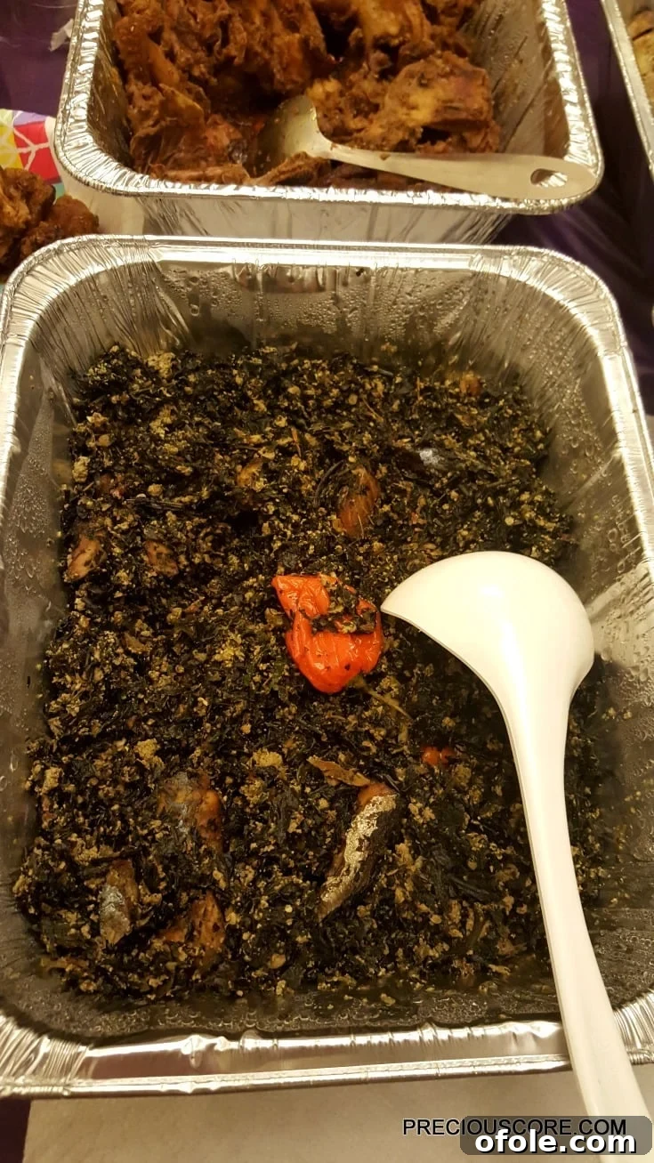 Meeting Digest 3 A bowl of bitterleaf and egusi soup with fish, a rich Cameroonian vegetable dish.
