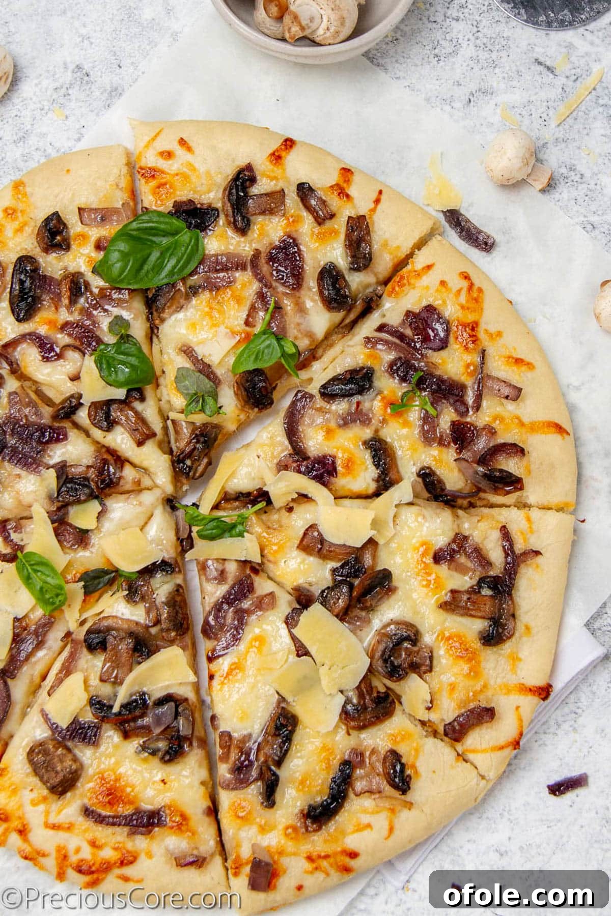 Gourmet Mushroom Pizza at Home 2 Pizza topped with mushrooms and fresh basil.