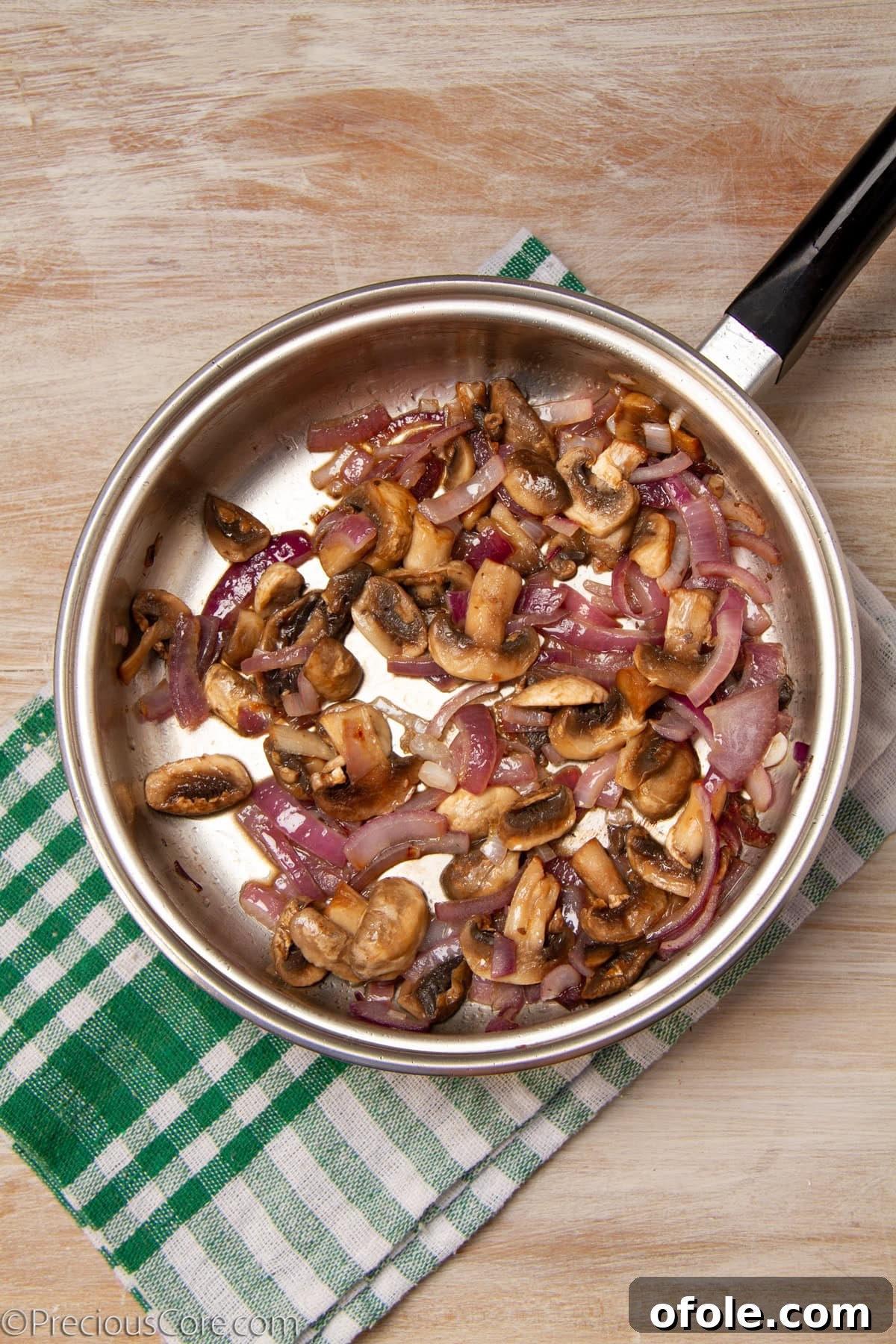 Homemade Mushroom Pizza Perfection 12 Caramelized onions and sliced mushrooms cooking together in a pan, achieving a golden brown color.