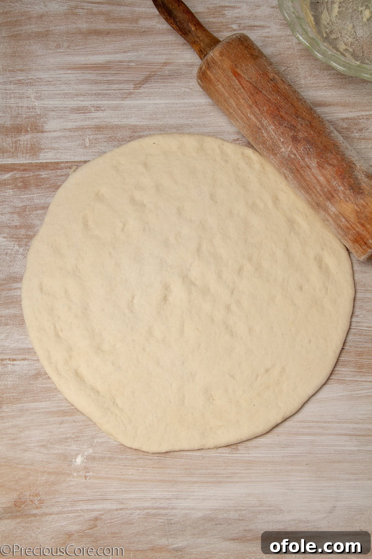 Homemade Mushroom Pizza Perfection 13 Pizza dough rolled out into a large circular shape, ready for toppings.