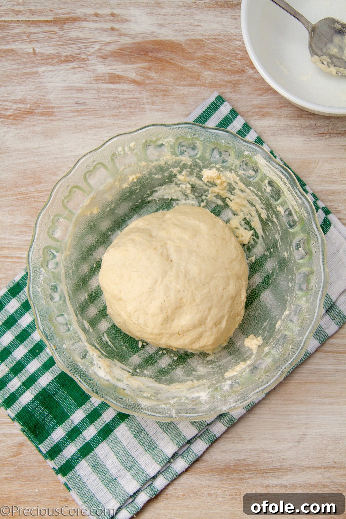 Homemade Mushroom Pizza Perfection 9 A perfectly kneaded ball of pizza dough resting on a countertop, smooth and elastic.