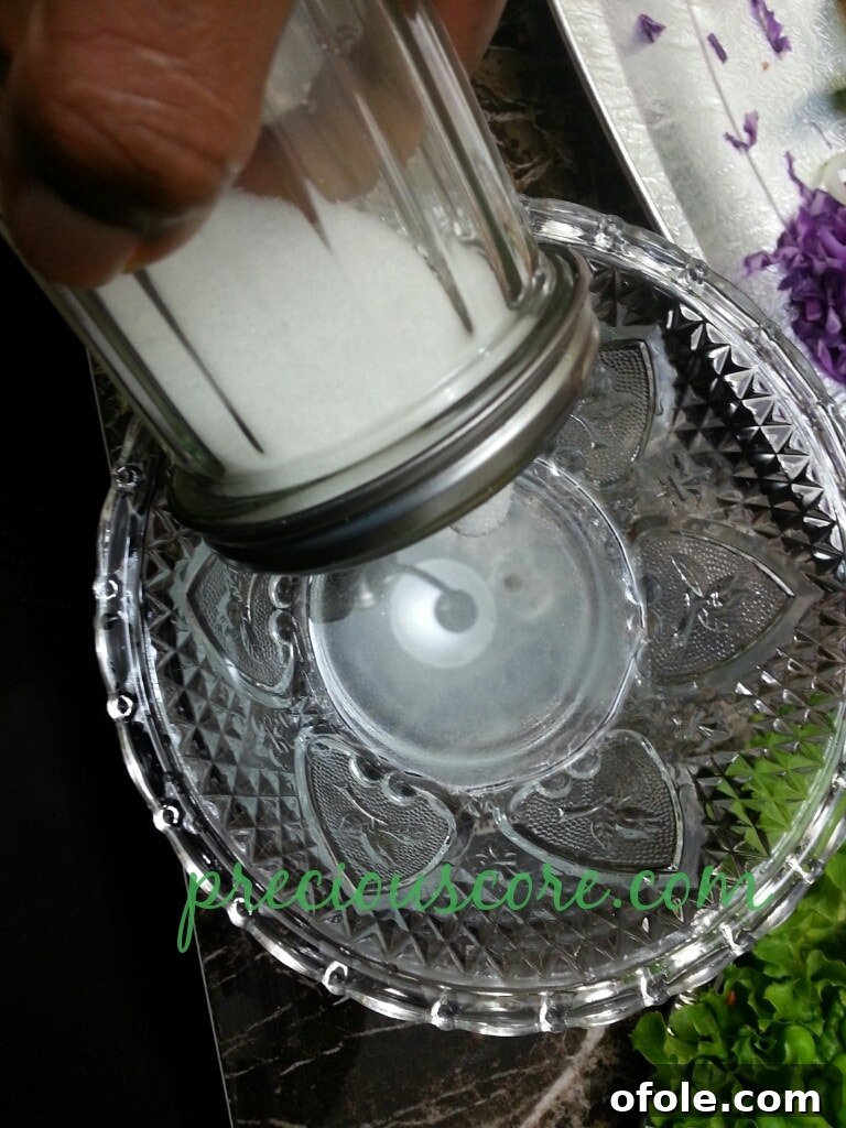 Vibrant Cameroon Salad with Authentic Dressing 16 White vinegar being poured into a bowl.