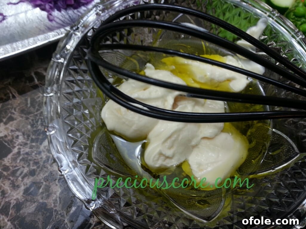 Vibrant Cameroon Salad with Authentic Dressing 18 Mayonnaise being added to the dressing ingredients.