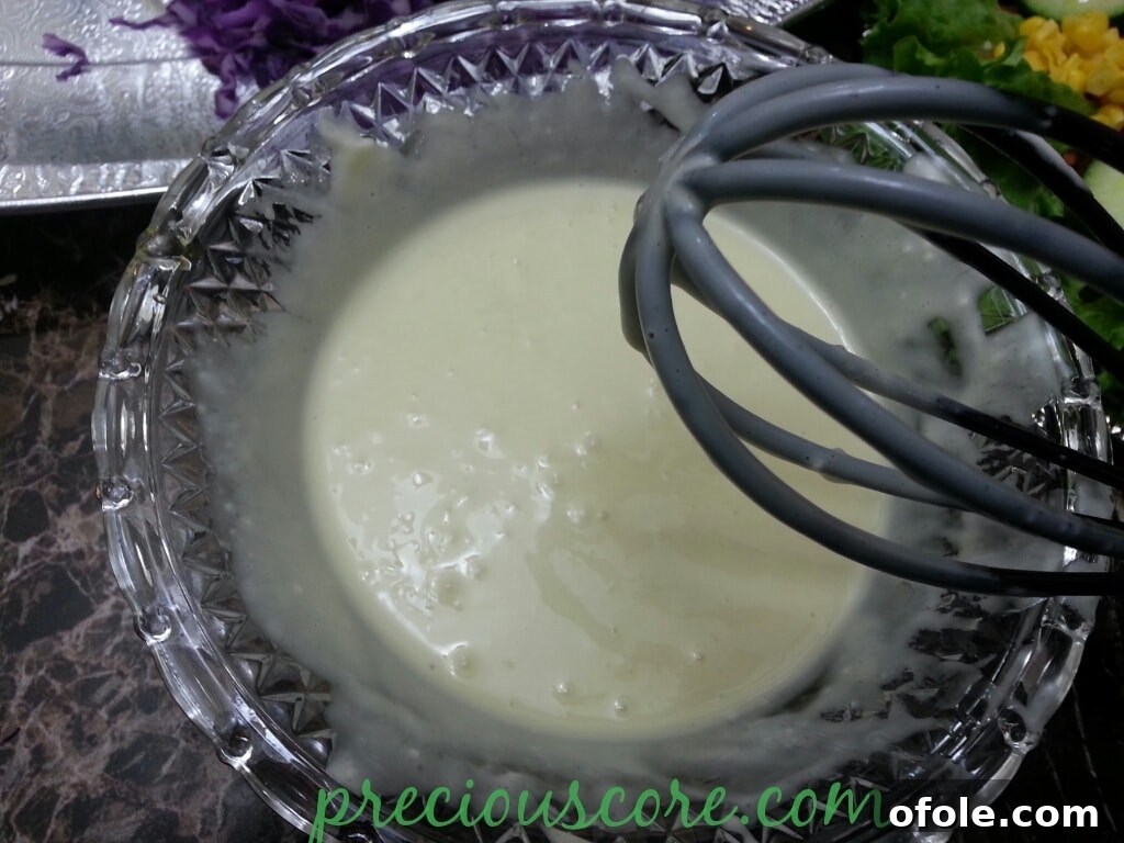Vibrant Cameroon Salad with Authentic Dressing 19 Whisking the salad dressing ingredients together.