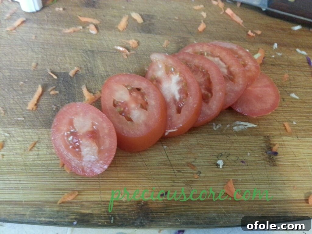 Vibrant Cameroon Salad with Authentic Dressing 7 Sliced tomatoes added to the salad.