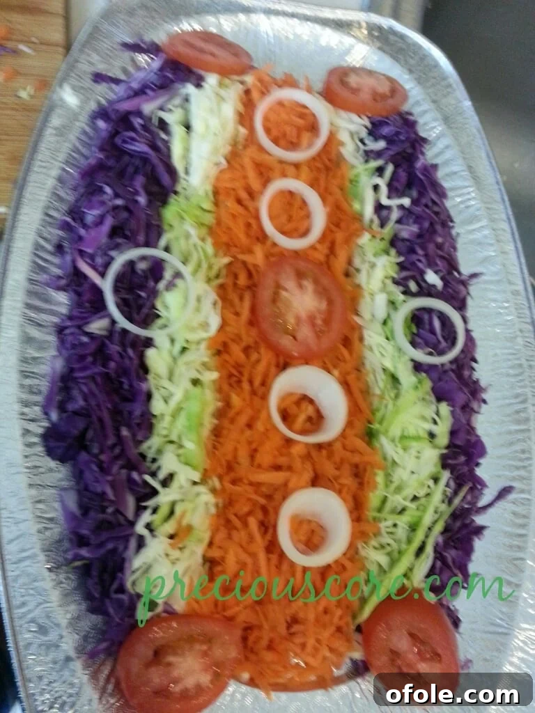 Vibrant Cameroon Salad with Authentic Dressing 8 Sliced onions layered onto the salad.