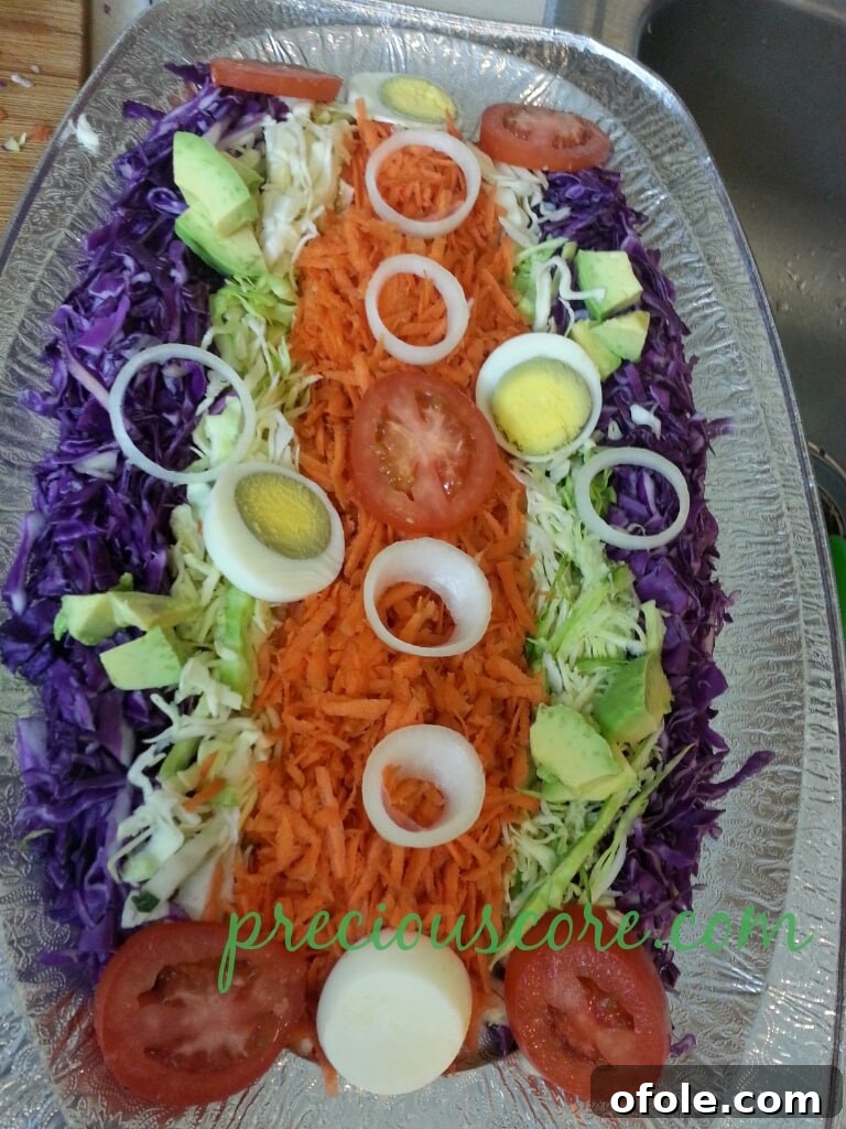 Vibrant Cameroon Salad with Authentic Dressing 9 Sliced hard-boiled egg on top of the salad.