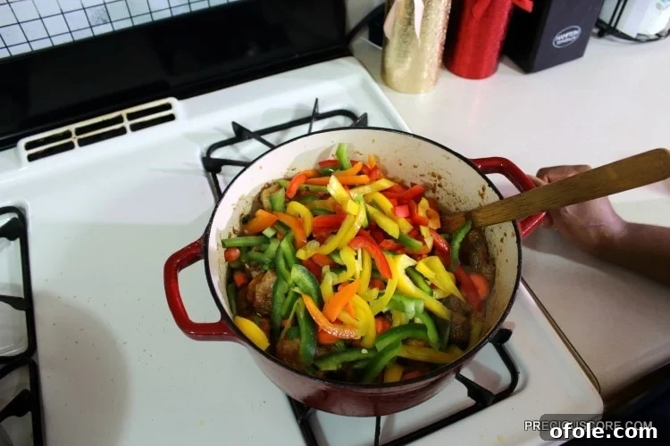 Ultimate Poulet DG Recipe 17 Colorful vegetables in a Dutch oven with chicken.