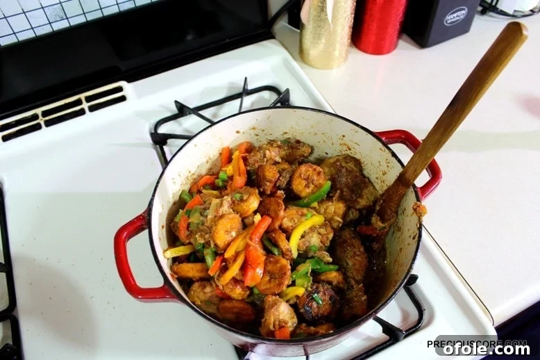 Ultimate Poulet DG Recipe 18 Wooden spoon in a Dutch oven of poulet DG.