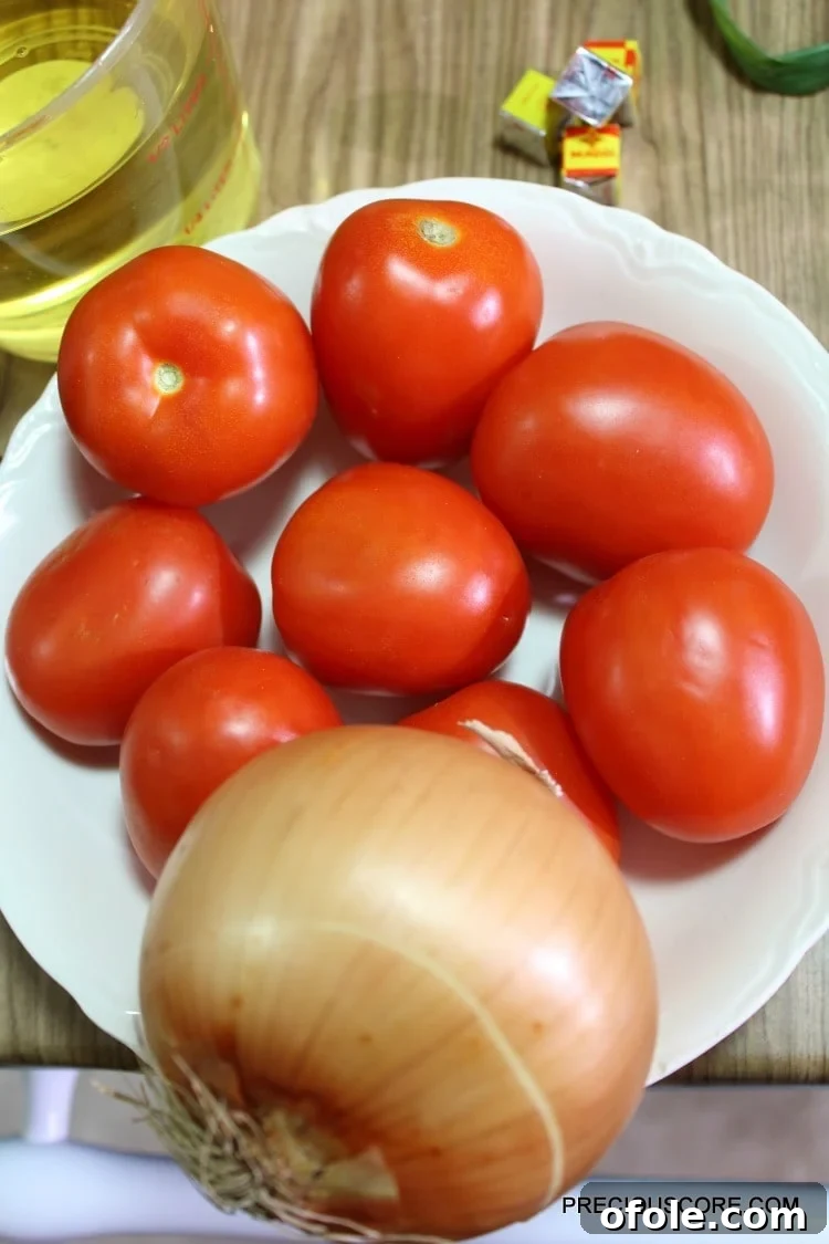 Ultimate Poulet DG Recipe 7 Tomatoes and onion in a bowl.