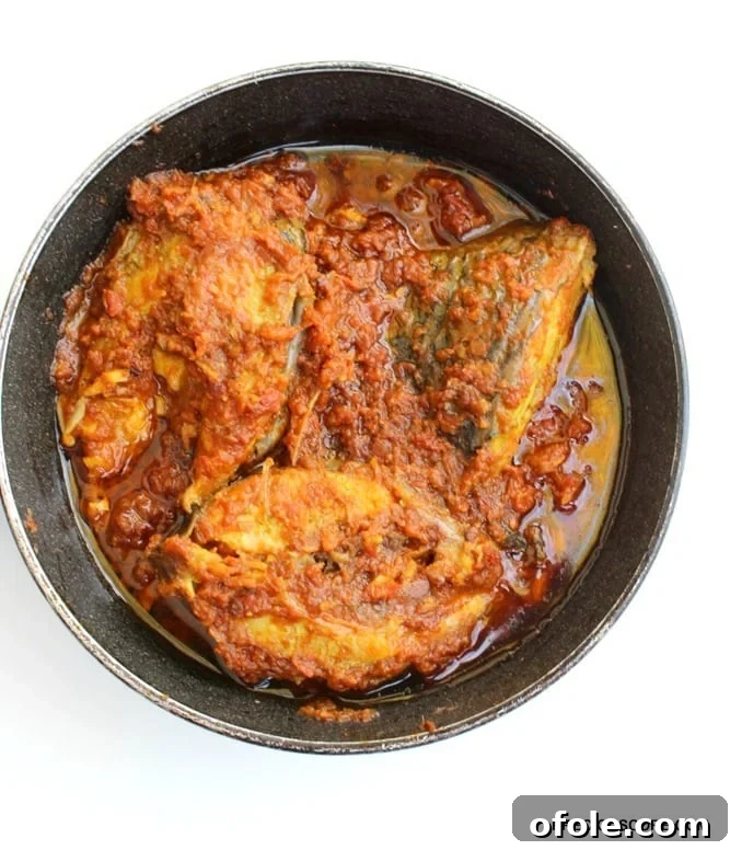 cameroon-fish-stew-recipe - A vibrant plate of Cameroonian Fish Stew with boiled rice.