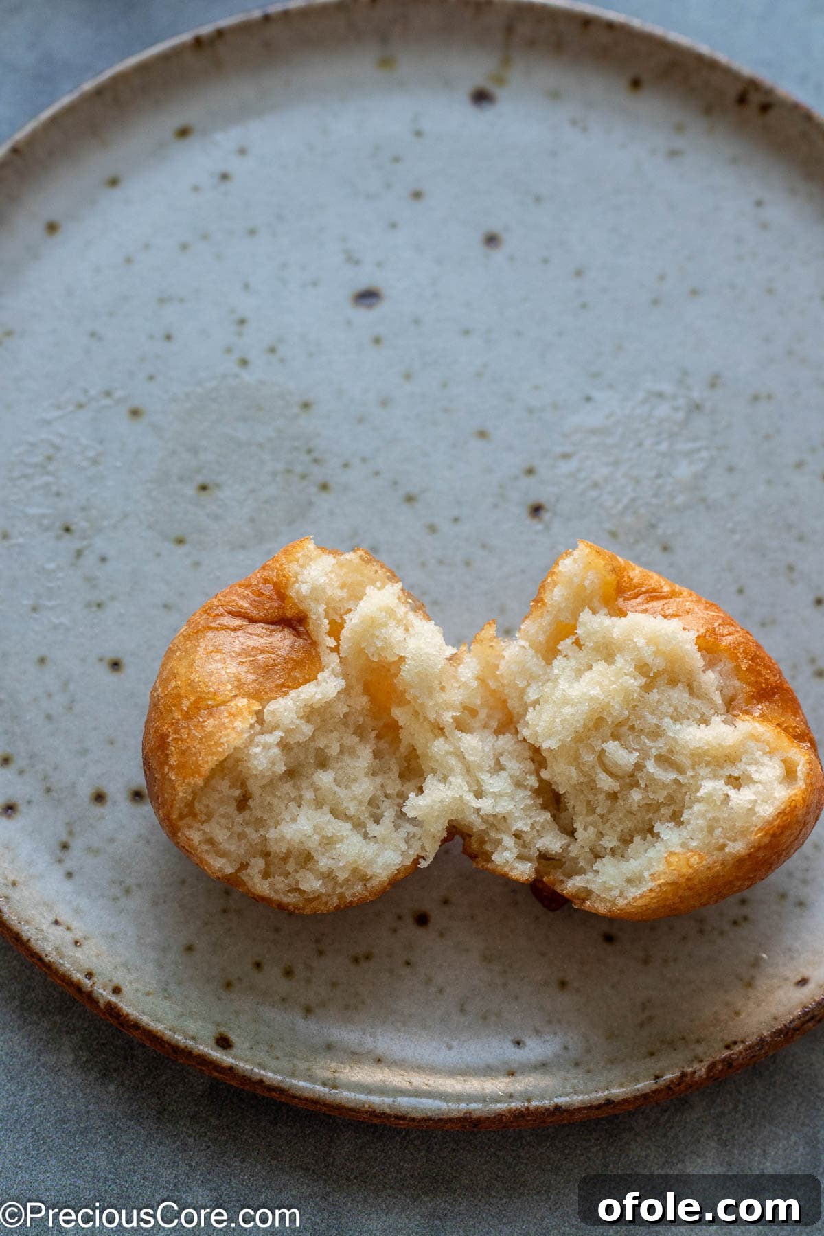 Homemade Fluffy Puff Puff 13 A perfectly fried Puff Puff, split open to reveal its beautifully airy and fluffy interior texture.