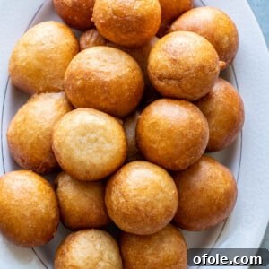 Homemade Fluffy Puff Puff 14 Puff Puff on a white tray.