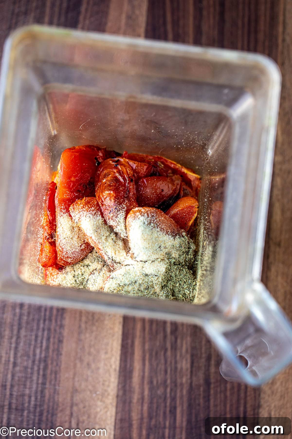 Slow Roasted Tomato Pizza Sauce 7 Roasted tomatoes, Italian seasoning, and garlic powder inside a blender, ready to be processed into sauce.