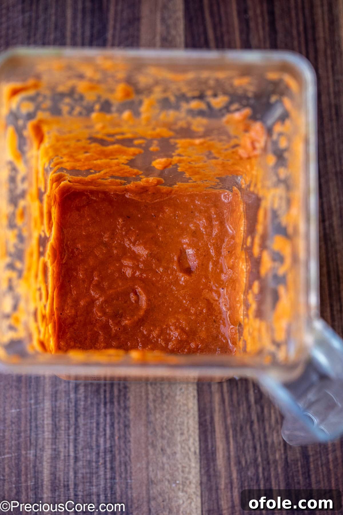 Slow Roasted Tomato Pizza Sauce 8 Smooth, rich blended roasted tomato sauce in a clear bowl, showcasing its vibrant color and texture.