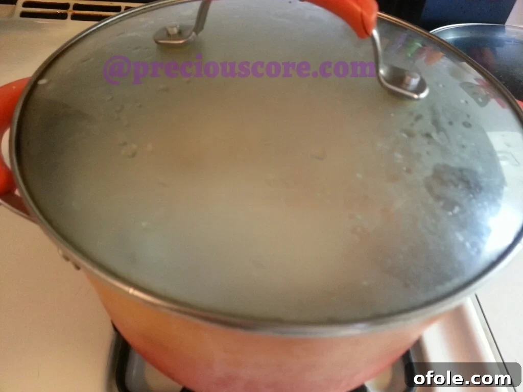 The pot of Fish Pepper Soup simmering gently on the stovetop